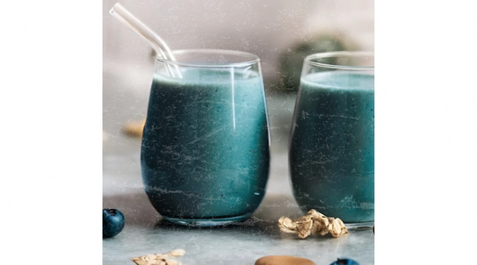 Blue-green superfood smoothie with glass straw, blueberries, and walnuts — made with Elyxar by Apotheka Superfoods for clean energy and gut health.