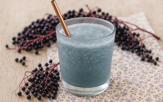 Wild super-berry smoothie made with Elyxar superfood blend, elderberry, blueberries, and banana for antioxidant and immune system support.