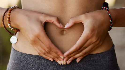Hands forming a heart over toned stomach — symbolizing gut health support from Elyxar’s superfood complex for digestion, energy, and full-body wellness.