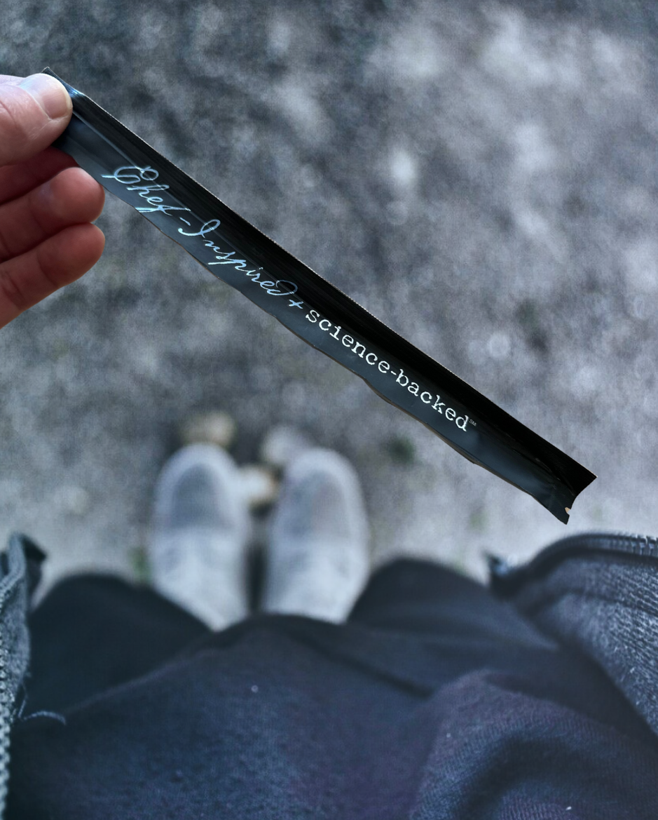 Close-up of the top of Elyxar Daily Superfood Complex pouch showing “Chef-Inspired + Science-Backed” — Apotheka Superfoods’ signature wellness blend.